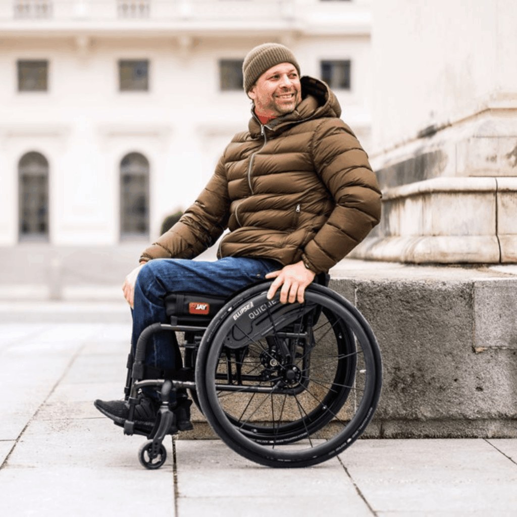 Wheelchair user out in the community, supported by assistive technology